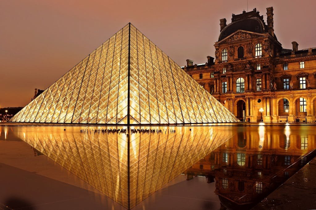 Louvre Pyramid illuminated at night in Paris