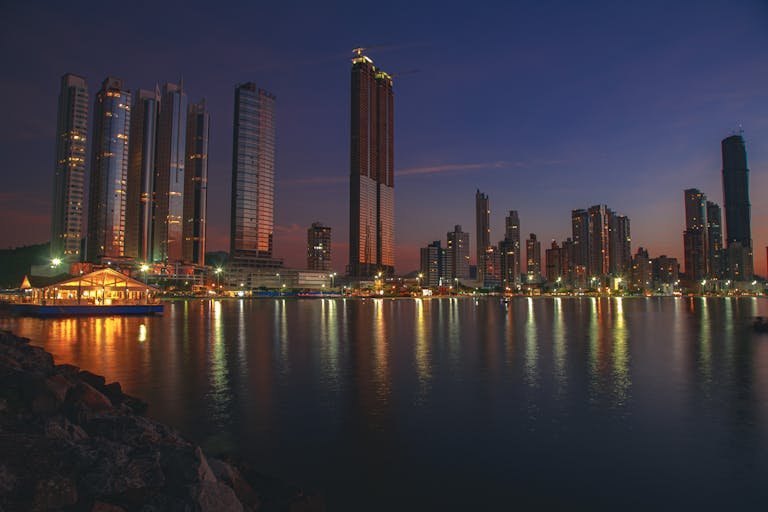 Stunning dusk cityscape of Balneário Camboriú, Brazil with reflections on the waterfront.