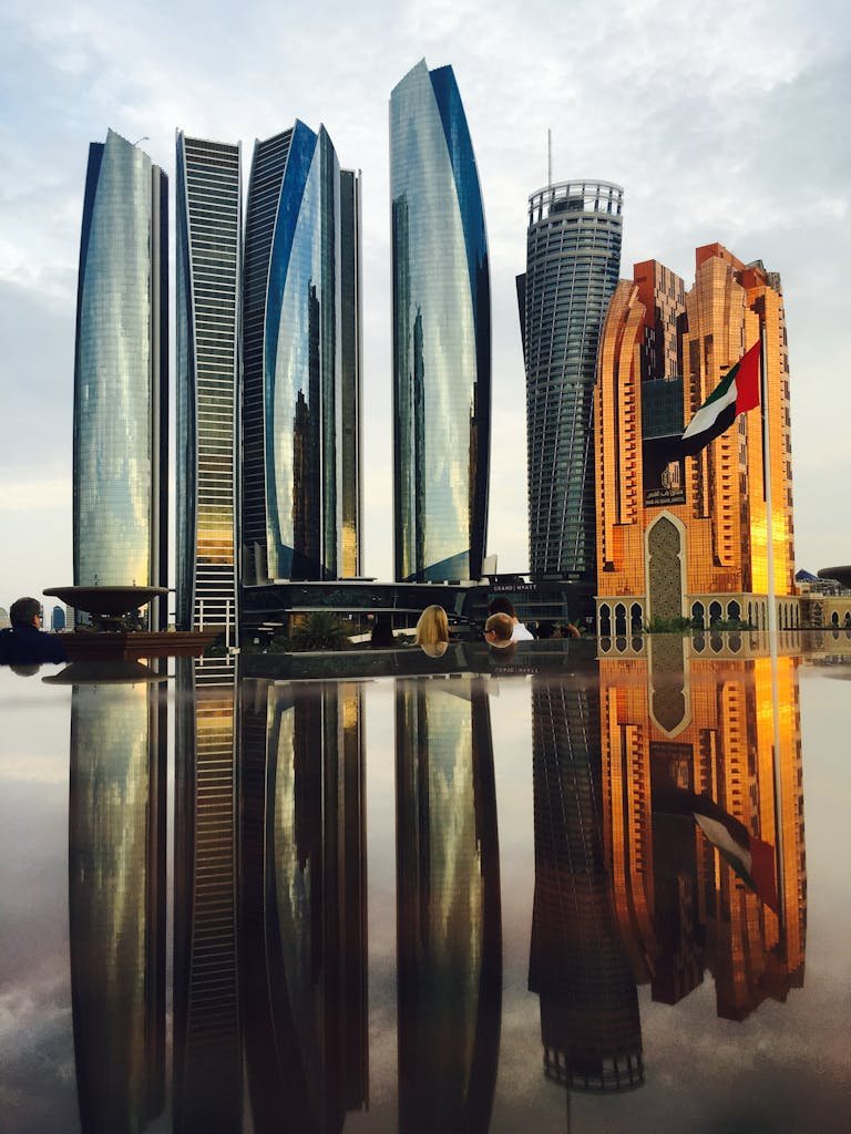 Stunning view of Abu Dhabi's skyline with modern skyscrapers reflecting beautifully at twilight.