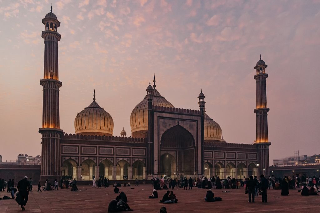 A stunning view of Jama Masjid in Delhi at dusk, showcasing Mughal architecture and vibrant evening sky.