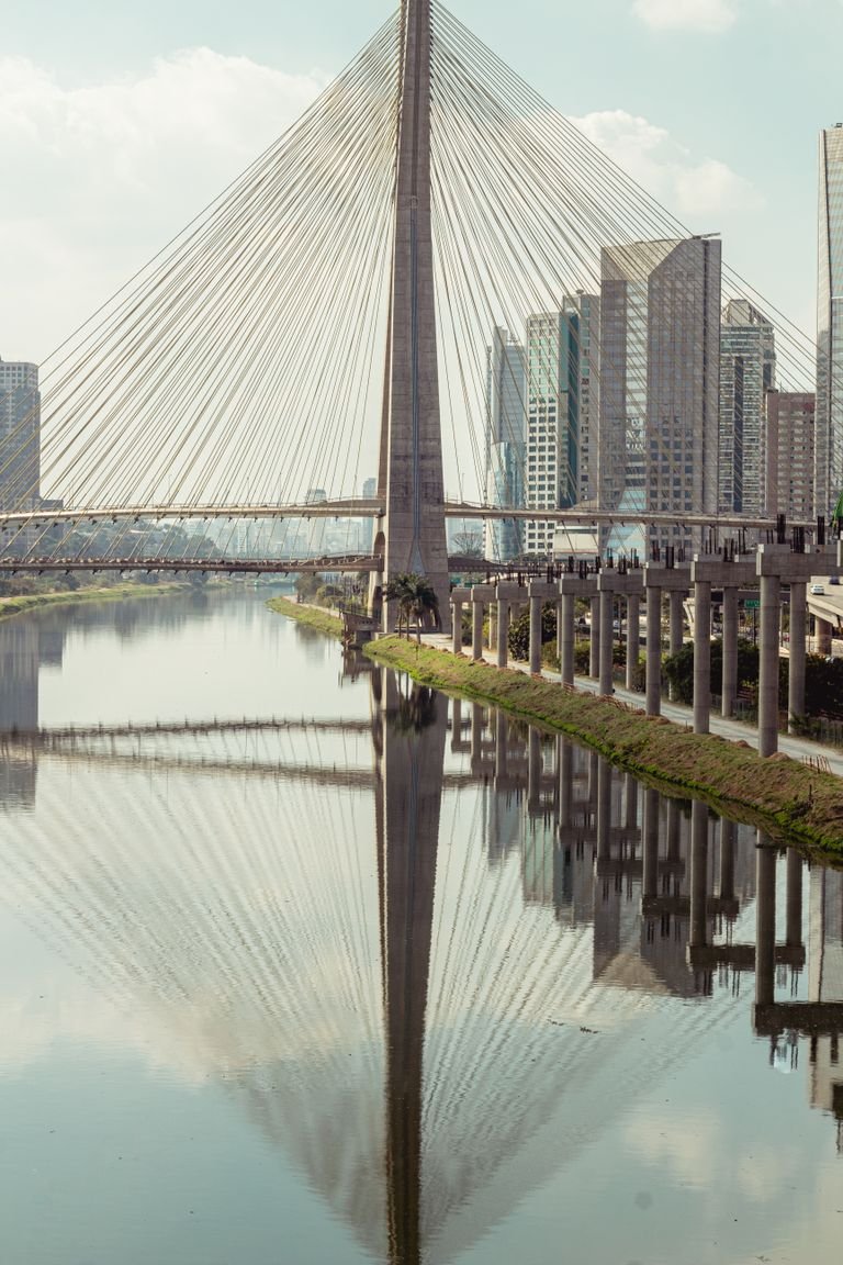 A stunning view of the Octávio Frias de Oliveira Bridge in São Paulo, reflecting on the river below.