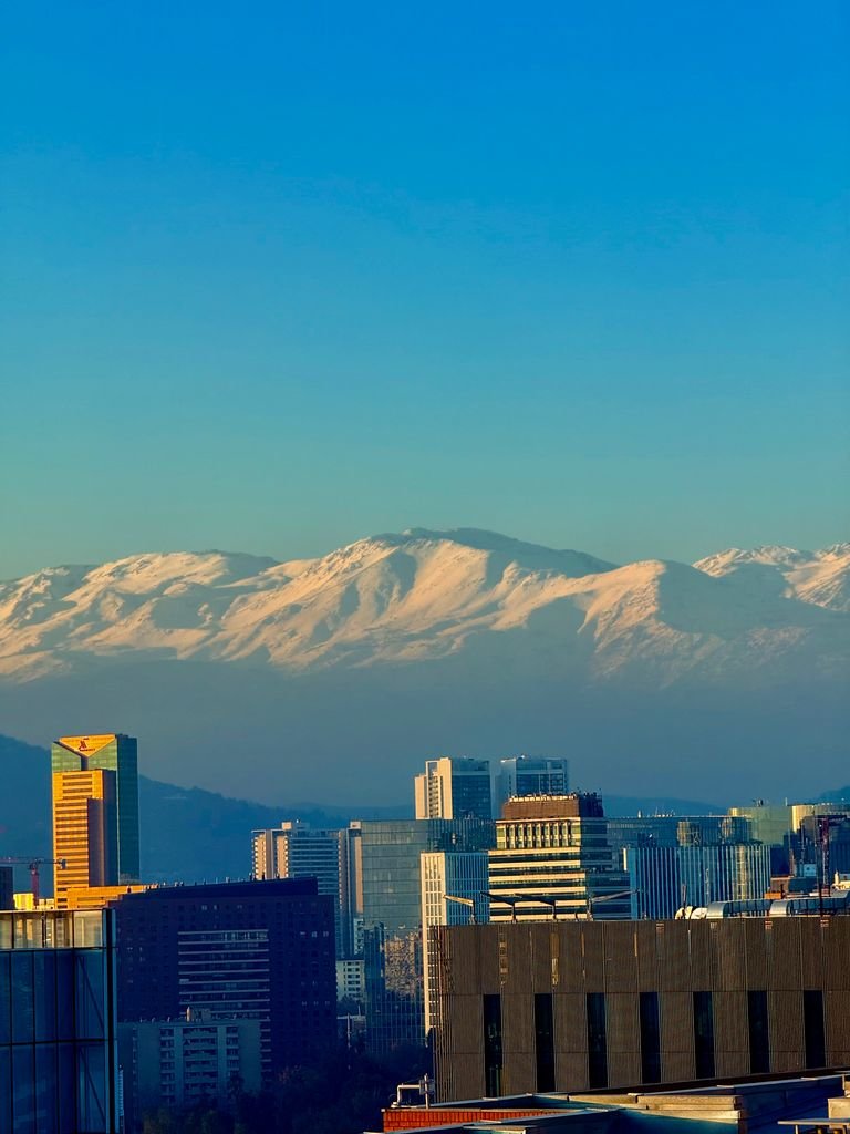 Captivating view of Santiago's skyline with snow-capped Andes mountains towering in the background.