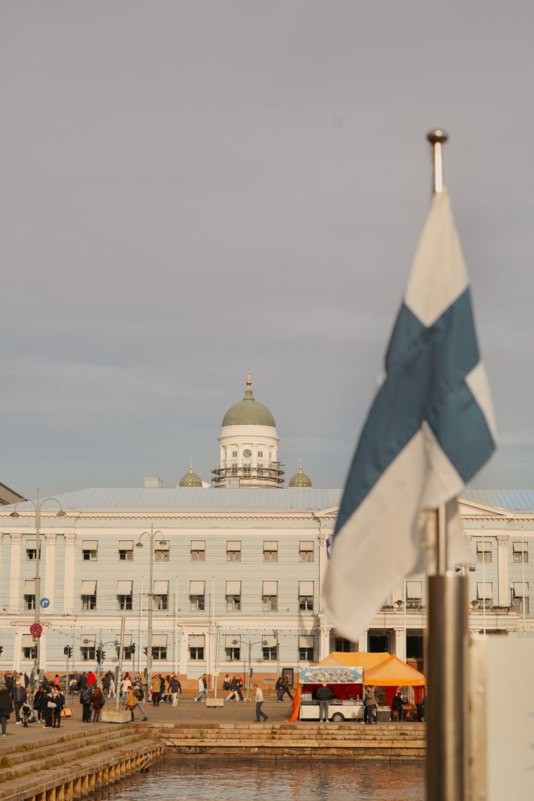 Finnish flag waves near Helsinki Cathedral, Helsinki, Finland.