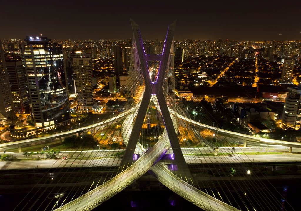 Stunning aerial night view of São Paulo's Octávio Frias de Oliveira bridge with city lights.