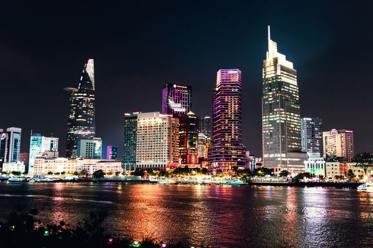 Stunning night view of Ho Chi Minh City illuminated skyline reflecting on Saigon River.