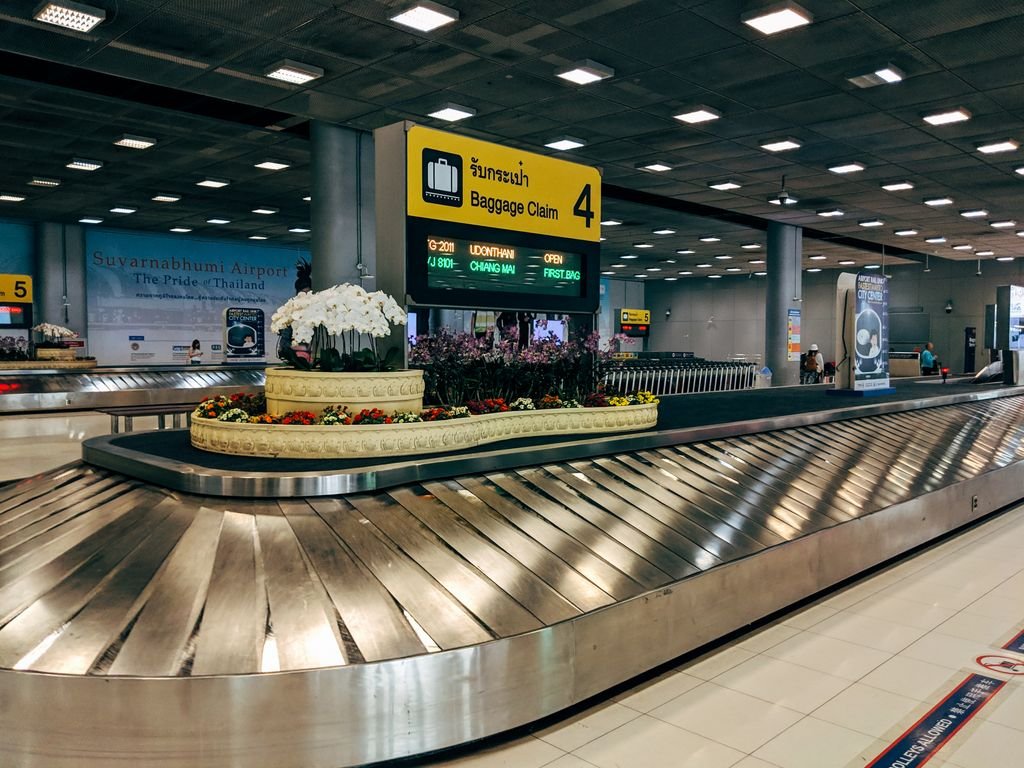 Checked bag on an airport baggage belt after a canceled flight